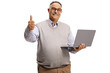 © Ljupco Smokovski - Casual mature man holding a laptop computer and gesturing a thumb up sign