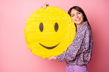 Sticker - Photo of charming person closed eyes hands holding hug big yellow emoji isolated on pink color background