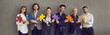 © Studio Romantic - Team of happy people making chain of jigsaw pieces. Studio group portrait of smiling entrepreneurs, coworkers and business colleagues standing together holding colorful puzzle parts. Teamwork concept