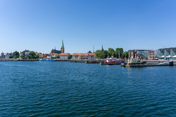 Sticker - cityscape of the harbor and old town of Helsingor in northern Denmark with colorful fishing boats in the foreground