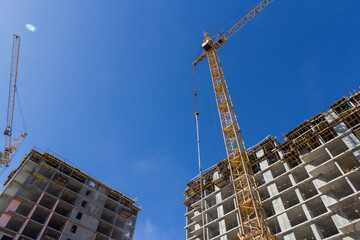 Poster - Construction crane at a construction site. Mechanisms for lifting construction materials. Lifting construction equipment