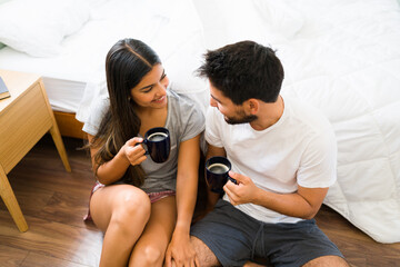 Wall Mural - Boyfriend bringing coffee to his girlfriend in the bedroom