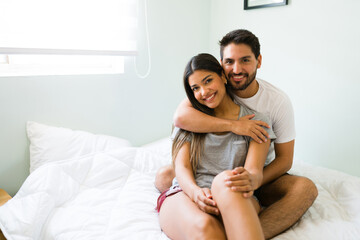 Wall Mural - Hispanic couple in bed getting up early