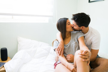 Wall Mural - Happy girlfriend giving a kiss to her partner