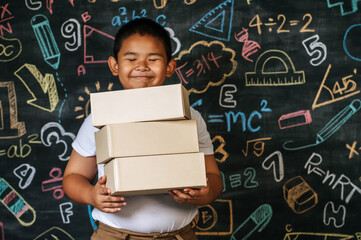 Child holding boxes in the classroom