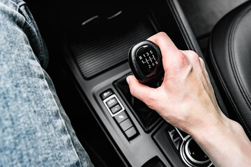 Driver shifting the gear on car manual gearbox.