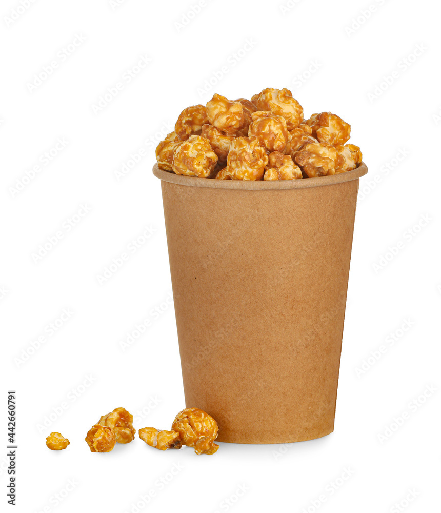 Paper cup with tasty caramel popcorn on white background