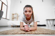 © fotofabrika - Sporty young woman doing plank exercise indoors at home