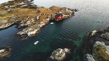 Rocky Islands With Red Boathouse Near Atlantic Ocean Road In Atlanterhavsveien, Norway. - Aerial Shot