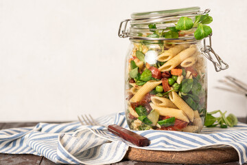 Wall Mural - Salad with various vegetables and pasta in a jar. Vegan food, Mediterranean food. Lunch or dinner in a jar, take away