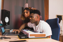 Black Friends Sharing Laptop With Recording Program On Screen