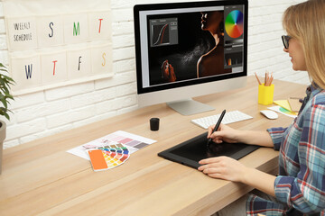 Poster - Professional retoucher working on graphic tablet at desk