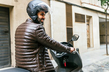 Hispanic Motorcyclist Driving Modern Bike On City Street