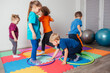 © oksix - Sport activities with hula hoops at kindergarten
