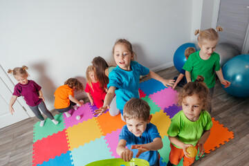 Sporty kids enjoying activities with young teacher
