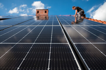 photovoltaic panels on the roof and intaller in the background