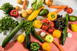 © TK-Photographie - Mix of vegetables and fruits on a white and pink background.