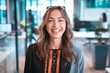 © Wavebreak Media - Portrait of caucasian businesswoman smiling and looking at camera with colleagues in background