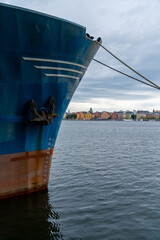 Sticker - vertical view of the cityscape of Stockholm on an overcast summer day with a large ship hull in the foreground