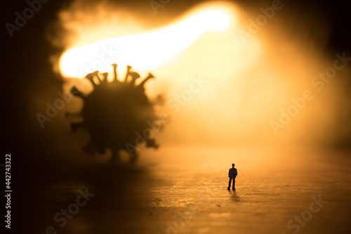 Defocused Businessman standing with corona virus or covid19 in cloudy background, Corona virus pandemic outbreak global crisis, Blurred or defocus technic
