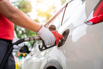 close-up hand of gas refueling worker wearing gloves is refueling customers, Pumping equipment gas at gas station.