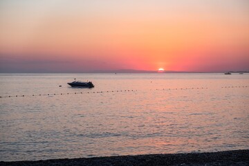 Wall Mural - Dusk sea water wave dawn. red sky