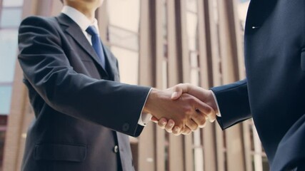 Wall Mural - Confident businessman and his colleague in front of modern office building. Financial investors are talking outdoor. Banking and business.