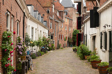 A Narrow Street With Flower Pots In Amersfoort.