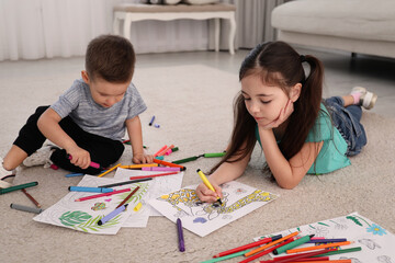 Poster - Cute children coloring drawings on floor at home