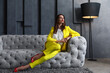 © New Africa - Beautiful businesswoman on sofa indoors. Luxury lifestyle