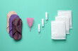 Different menstrual hygiene products on turquoise background, flat lay