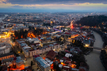 Evening drone view of the ancient city of Kutaisi, located on the two banks of the Rioni River and a center of culture, Georgia