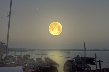 Wall Mural - Big full moon over the lake and boats