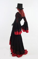 Sticker - full length portrait of red haired woman wearing long black gothic vampire gown. standing pose on white studio background