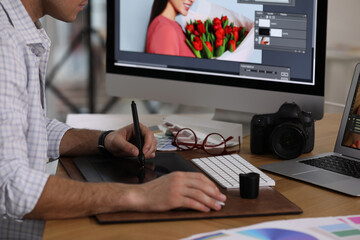 Poster - Professional retoucher working on graphic tablet at table, closeup