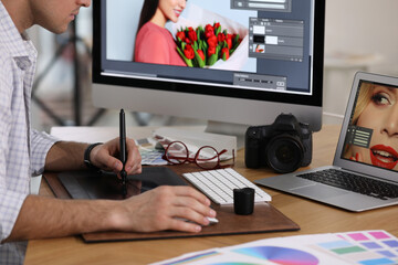 Poster - Professional retoucher working on graphic tablet at table, closeup