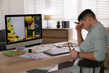 Poster - Tired retoucher at workplace with computer in office