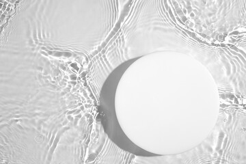 empty white circle podium on transparent clear calm water texture with splashes and waves in sunligh