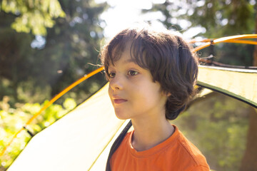 Sticker - A boy looks out of a tent