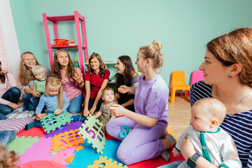 Wall Mural - Lovely babies and their mothers at the nursery or daycare