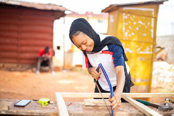 local african carpenter at work smiling