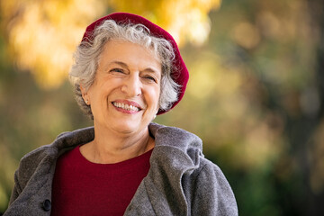 Wall Mural - Senior happy woman in autumn