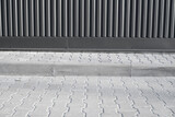 Fototapeta Perspektywa 3d - Brick pavement tile on a street near industrial building. Urban texture as background.