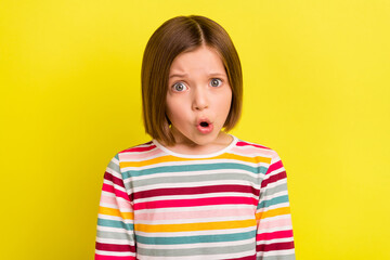 photo portrait little girl in striped clothes looking amazed opened mouth isolated bright yellow col