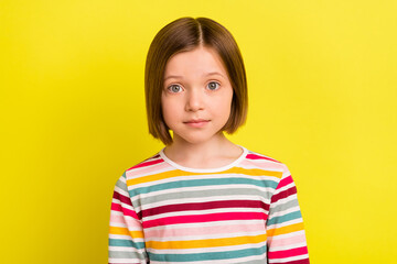 photo of charming pretty young little girl wear striped shirt casual clothes isolated on yellow colo