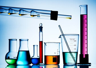 Wall Mural - different laboratory glassware with color liquid and with reflection