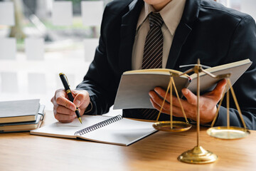 justice and law concept. the judge in a courtroom with the gavel, male judge with writing documents on the table in office, closeup