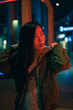 © ADDICTIVE STOCK - Portrait of Asian girl posing near to red neon light on the street