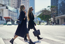 Stylish Girlfriends With Accessories Crossing Urban Road