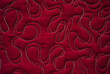 Close up texture of quilting by free-motion machine technique. on dark red clothes Background